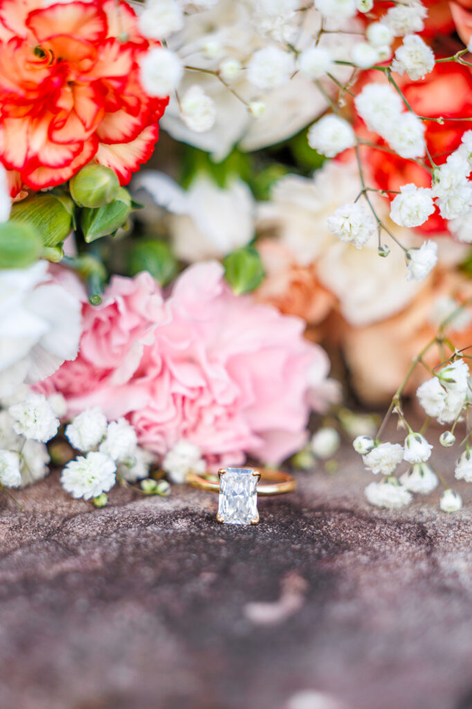 Bride in a white lace wedding gown holding a pastel bouquet at Carrollock Farms, a rustic barn wedding venue near Raleigh, North Carolina