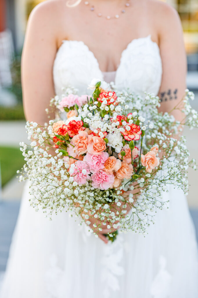 Bride in a white lace wedding gown holding a pastel bouquet at Carrollock Farms, a rustic barn wedding venue near Raleigh, North Carolina