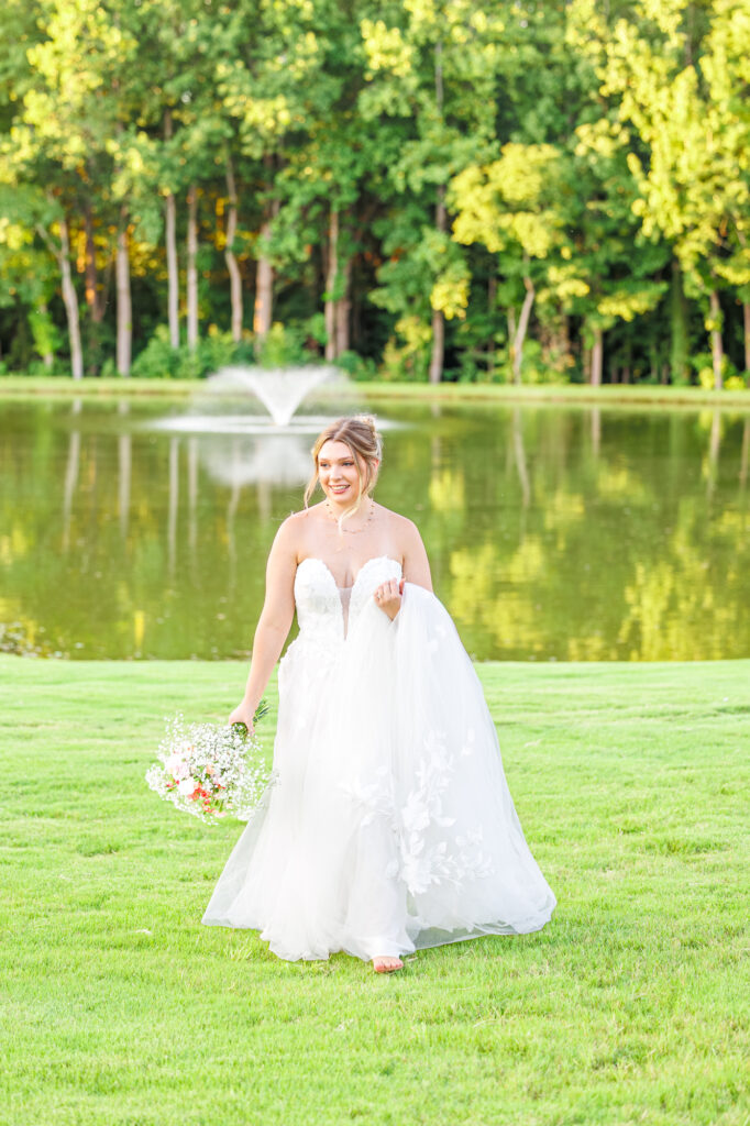 Bride in a white lace wedding gown holding a pastel bouquet at Carrollock Farms, a rustic barn wedding venue near Raleigh, North Carolina