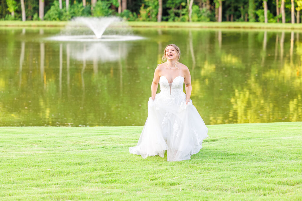 Bride in a white lace wedding gown holding a pastel bouquet at Carrollock Farms, a rustic barn wedding venue near Raleigh, North Carolina