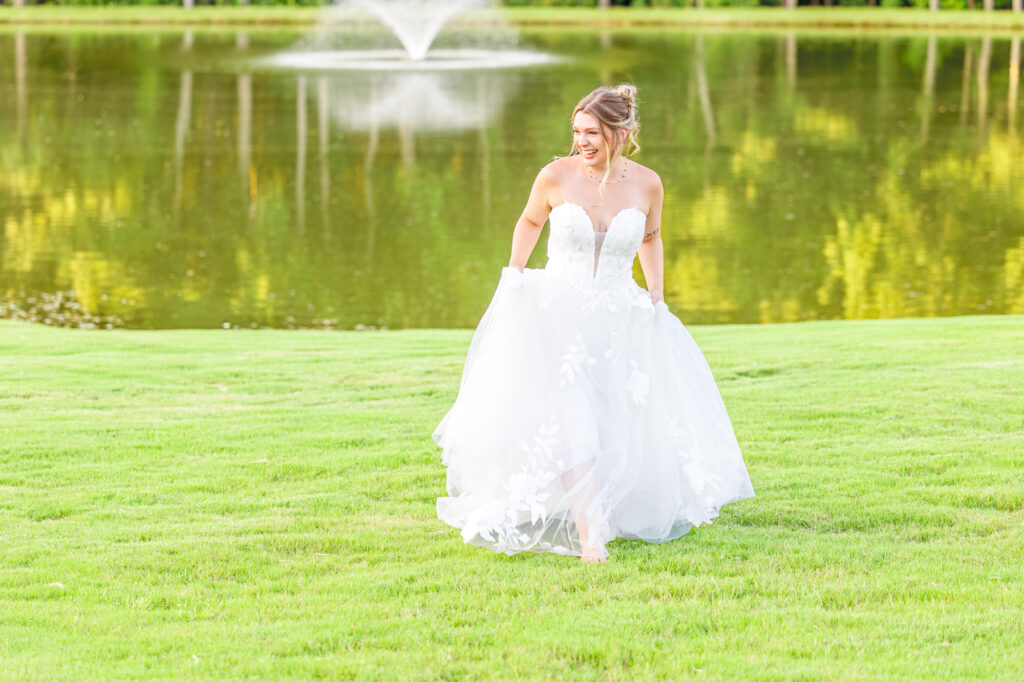 Bride in a white lace wedding gown holding a pastel bouquet at Carrollock Farms, a rustic barn wedding venue near Raleigh, North Carolina