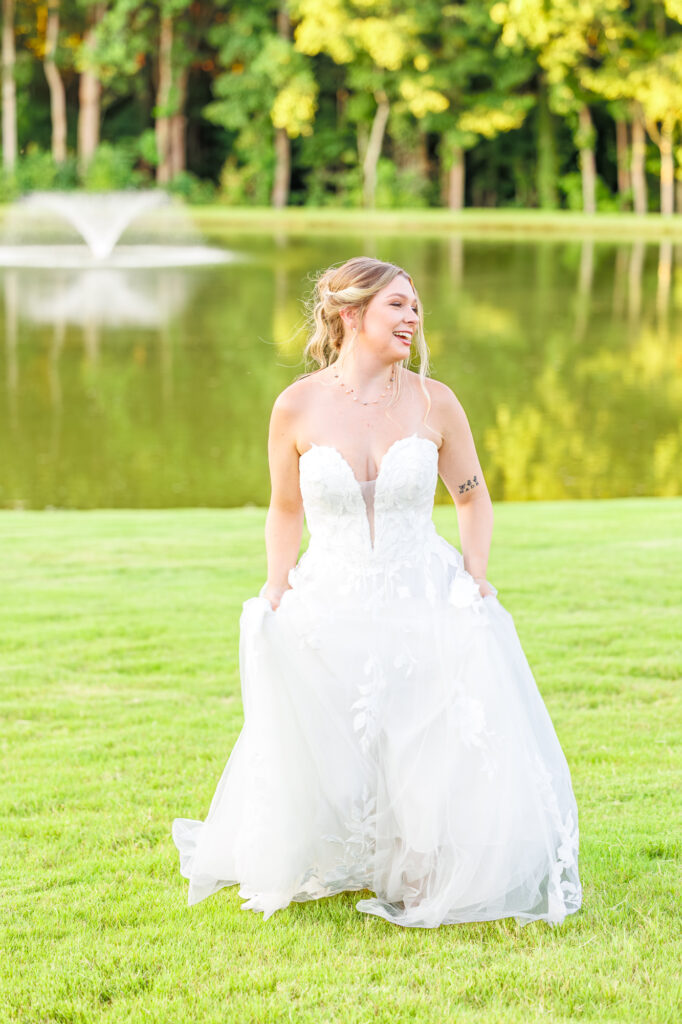Bride in a white lace wedding gown holding a pastel bouquet at Carrollock Farms, a rustic barn wedding venue near Raleigh, North Carolina