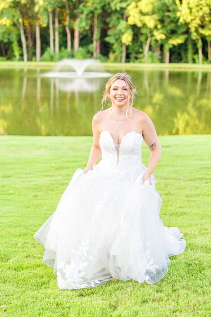 Bride in a white lace wedding gown holding a pastel bouquet at Carrollock Farms, a rustic barn wedding venue near Raleigh, North Carolina