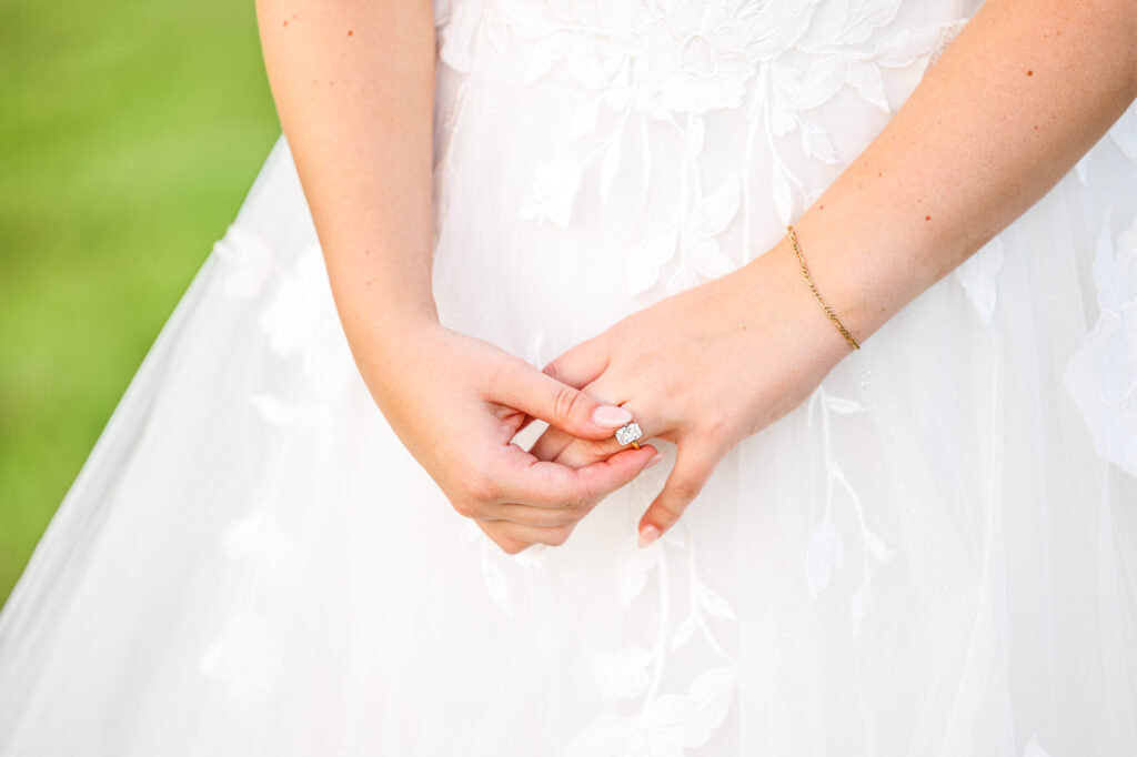 Bride in a white lace wedding gown holding a pastel bouquet at Carrollock Farms, a rustic barn wedding venue near Raleigh, North Carolina