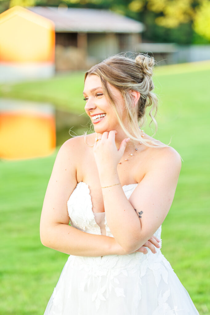 Bride in a white lace wedding gown holding a pastel bouquet at Carrollock Farms, a rustic barn wedding venue near Raleigh, North Carolina
