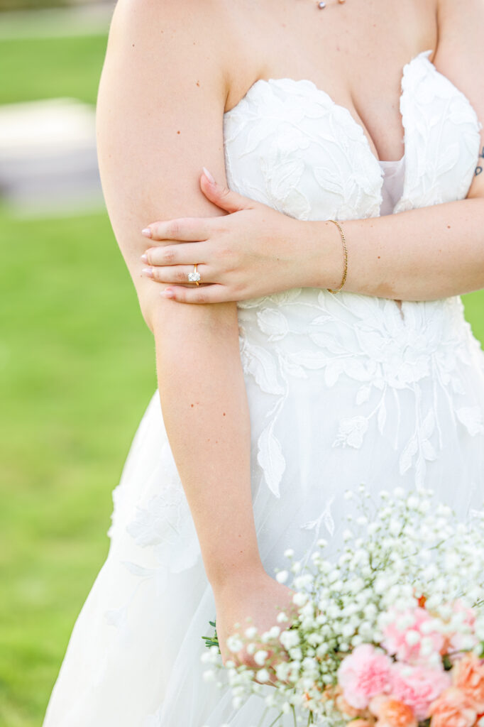Bride in a white lace wedding gown holding a pastel bouquet at Carrollock Farms, a rustic barn wedding venue near Raleigh, North Carolina