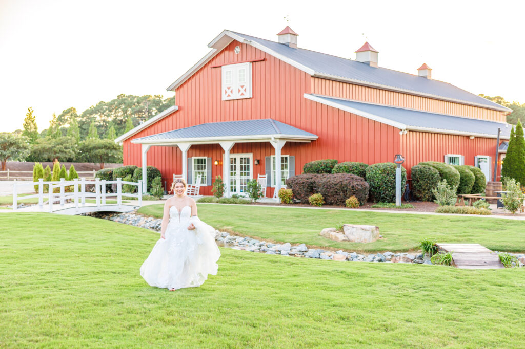 Bride in a white lace wedding gown holding a pastel bouquet at Carrollock Farms, a rustic barn wedding venue near Raleigh, North Carolina