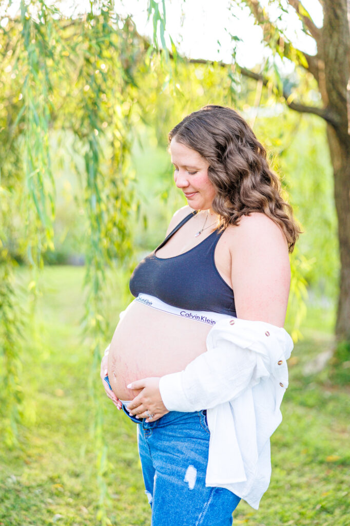 This dreamy maternity session took place at the NC Museum of Art featuring warm light, a whimsical willow tree and cotton candy skies.