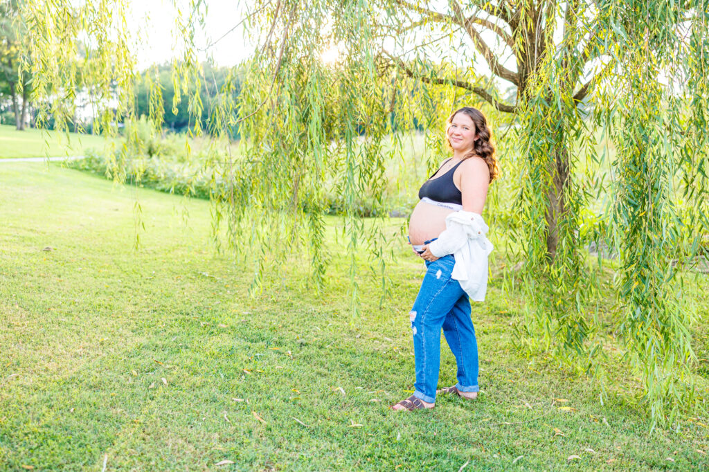 This dreamy maternity session took place at the NC Museum of Art featuring warm light, a whimsical willow tree and cotton candy skies.