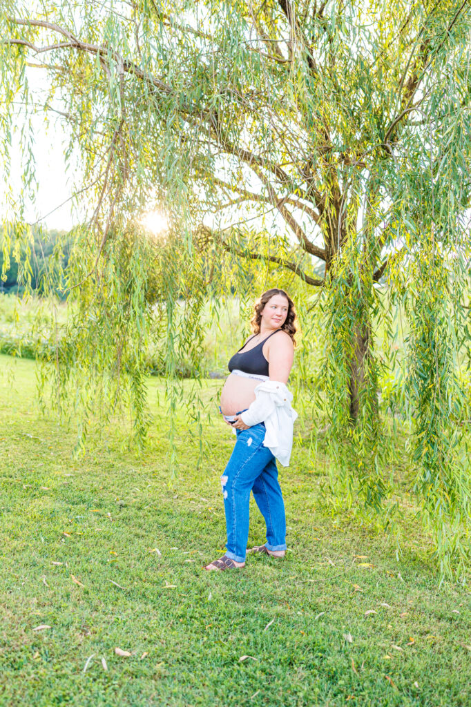 This dreamy maternity session took place at the NC Museum of Art featuring warm light, a whimsical willow tree and cotton candy skies.