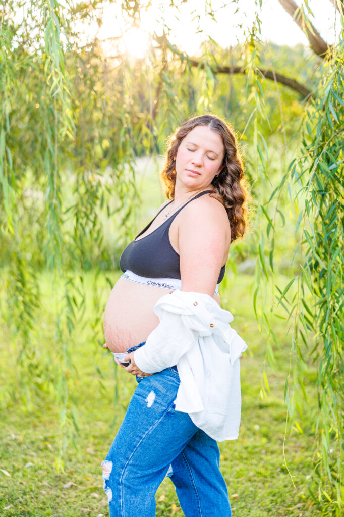 This dreamy maternity session took place at the NC Museum of Art featuring warm light, a whimsical willow tree and cotton candy skies.