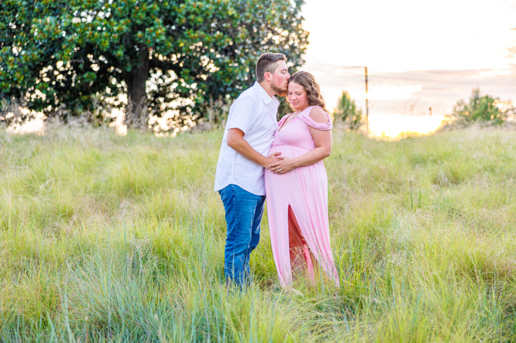 This dreamy maternity session took place at the NC Museum of Art featuring warm light, a whimsical willow tree and cotton candy skies.