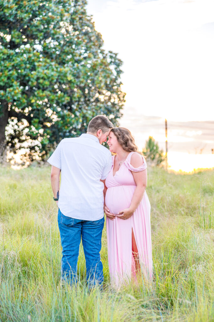 This dreamy maternity session took place at the NC Museum of Art featuring warm light, a whimsical willow tree and cotton candy skies.