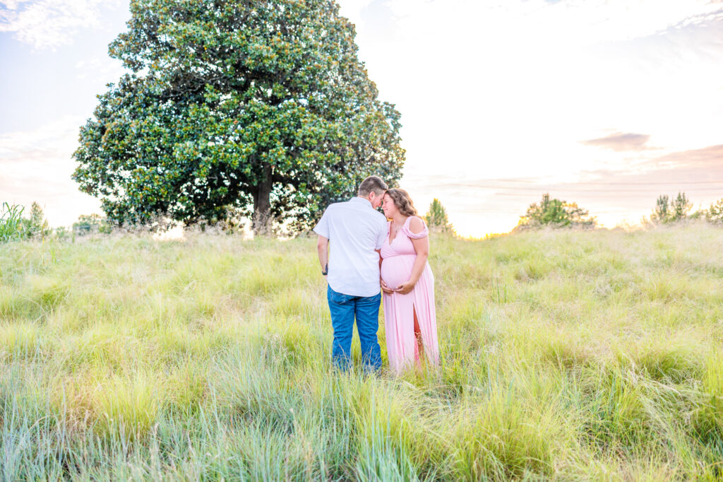 This dreamy maternity session took place at the NC Museum of Art featuring warm light, a whimsical willow tree and cotton candy skies.