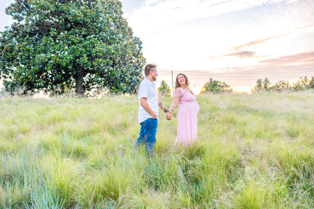 This dreamy maternity session took place at the NC Museum of Art featuring warm light, a whimsical willow tree and cotton candy skies.