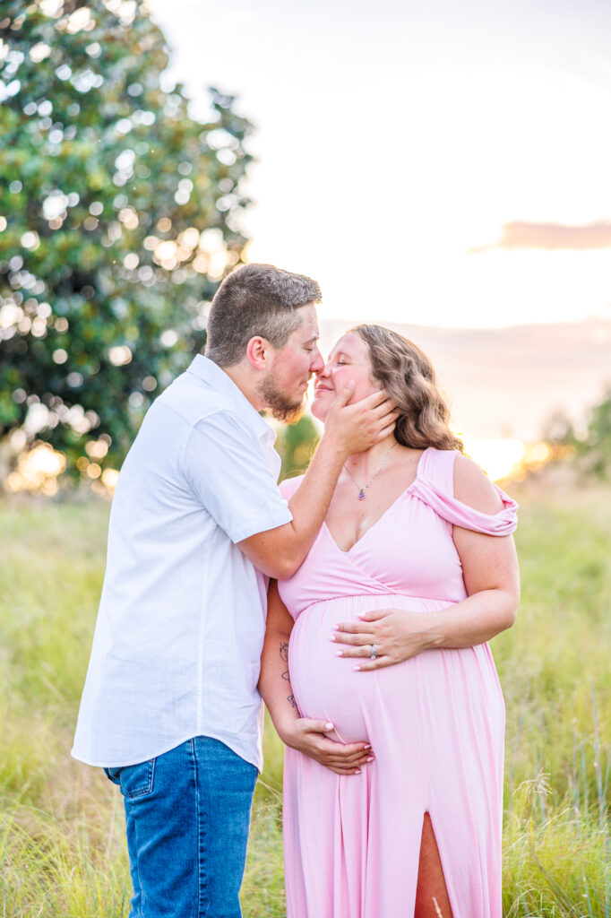 This dreamy maternity session took place at the NC Museum of Art featuring warm light, a whimsical willow tree and cotton candy skies.